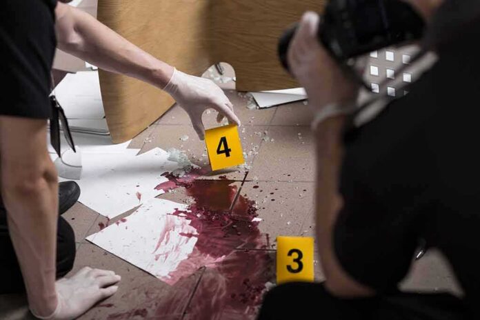 shutterstock_343837214 forensic investigators documenting a bloodstained crime scene