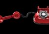 Red rotary dial telephone with handset off the hook