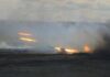 A tank firing in a smoky battlefield during a military exercise