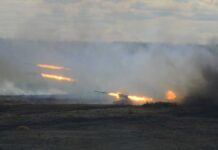 China Standoff: Army Unleashes Longer Punch A tank firing in a smoky battlefield during a military exercise